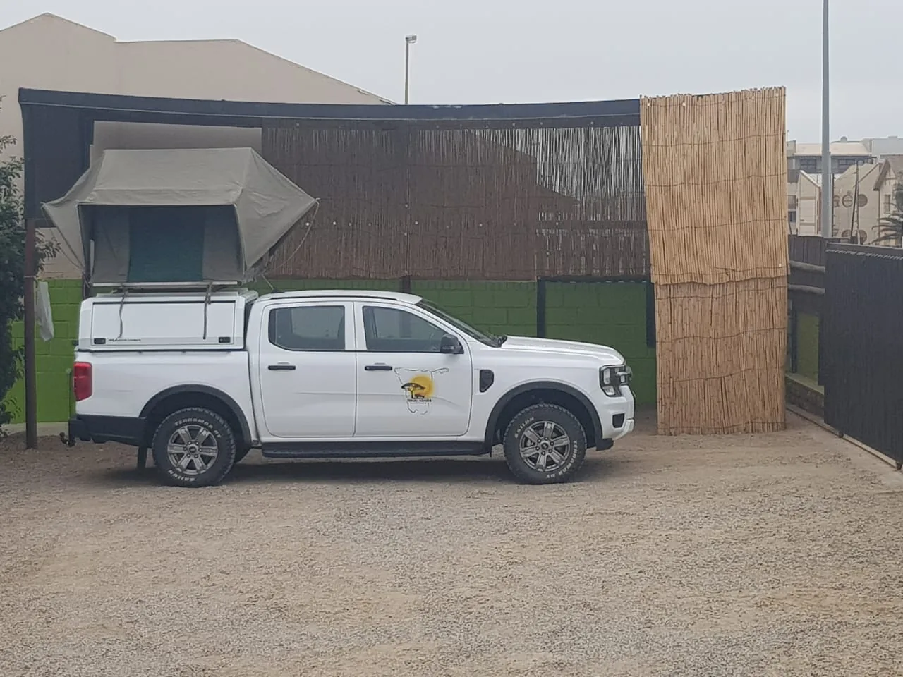 Vehicle parked in a covered camping bay