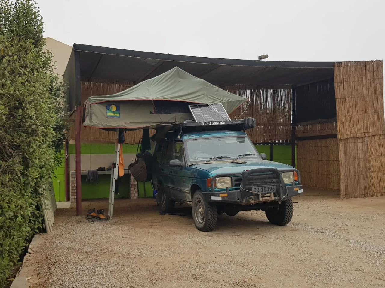 Overland vehicle in a sheltered camping pitch