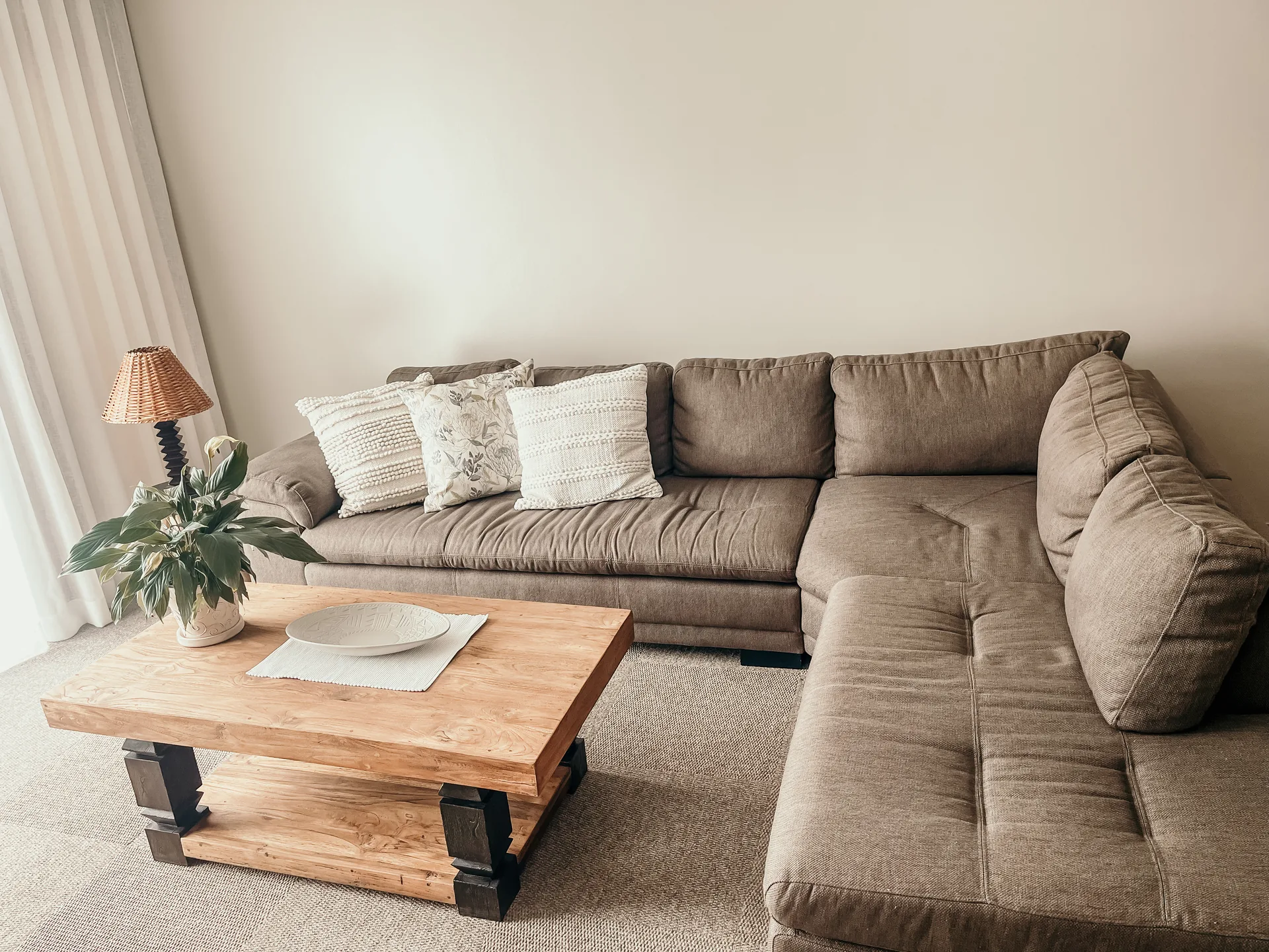 Moringa living room with large sectional sofa and wooden coffee table