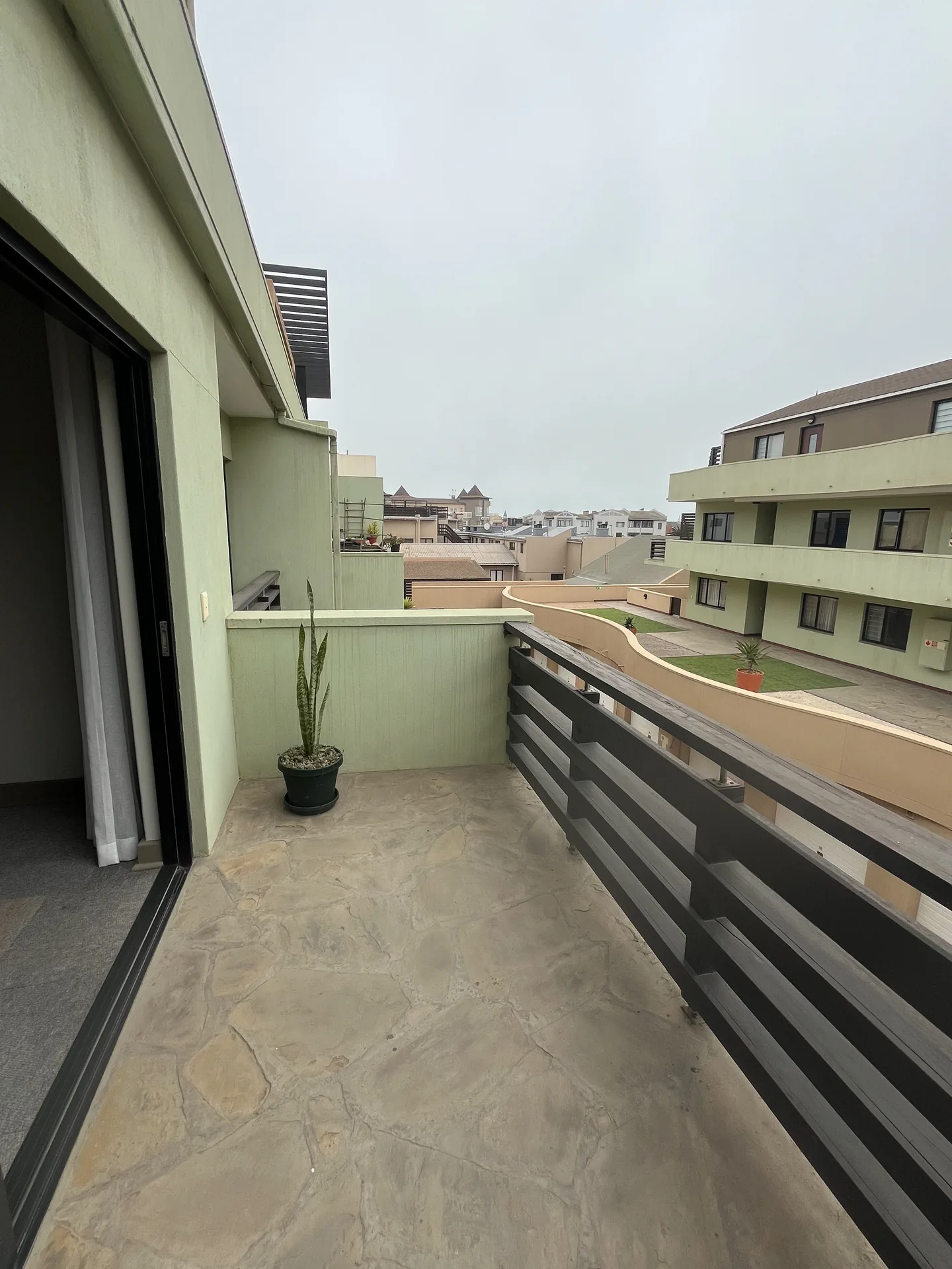Moringa private balcony overlooking the apartment courtyard