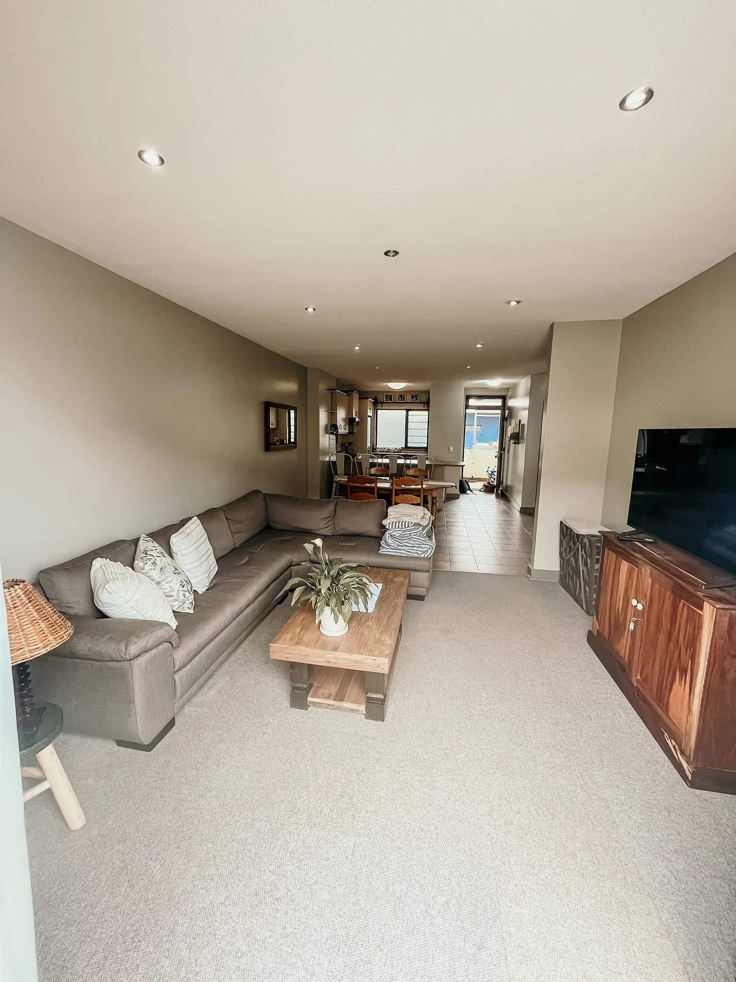 Moringa open-plan living room looking toward the dining area and kitchen