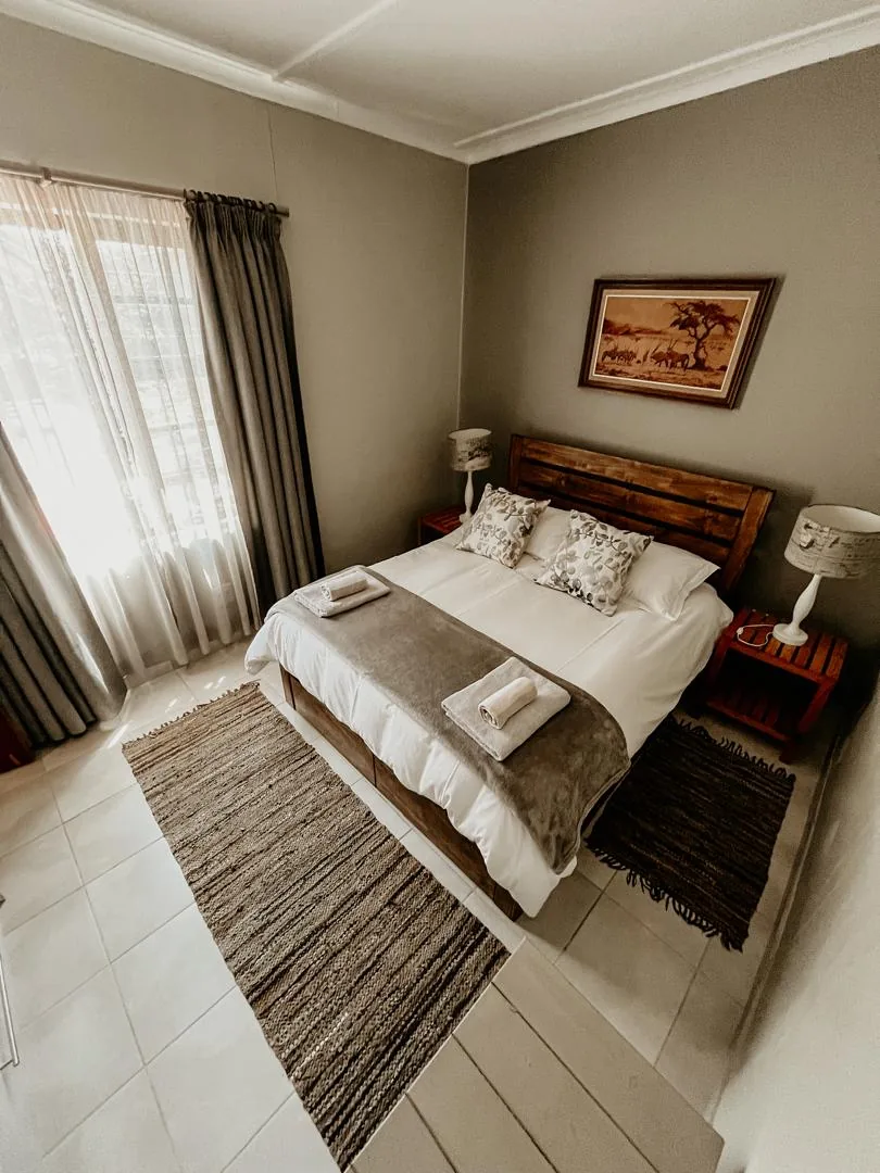 Oryx queen bedroom beside the curtained window