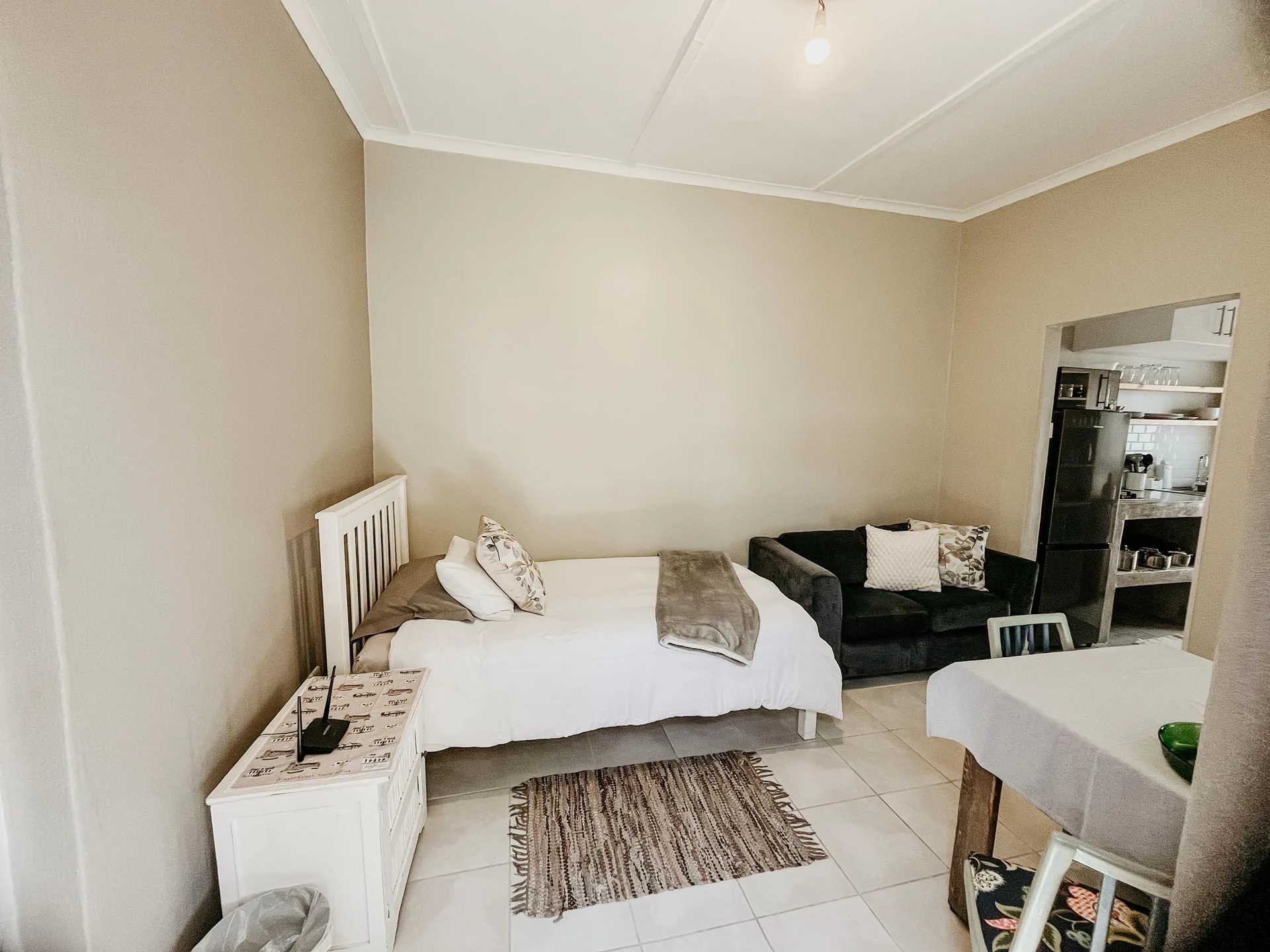 Oryx open-plan area with three-quarter bed, sofa and dining table