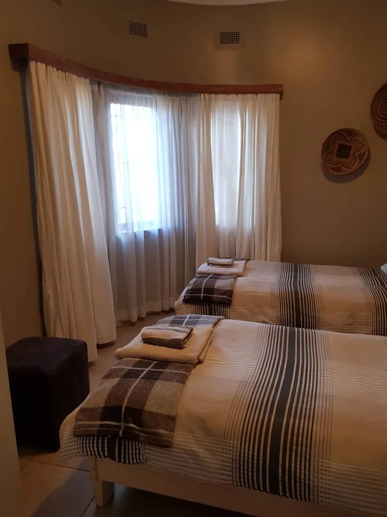 Rhino beds beside curtained windows